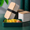 Lightweight Microwave-Safe Bento Lunch Box with a green container filled with food and wooden lids.