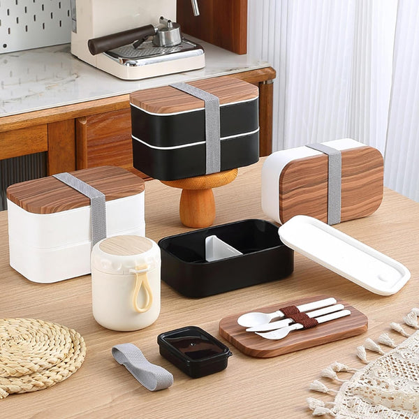 Lightweight Microwave-Safe Bento Lunch Box assortment on a wooden table with utensils and containers.