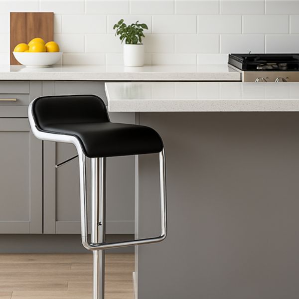 Low Back Barstool with Foot Rest in modern kitchen setting with sleek design and plush black seat.