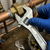Professional Adjustable Torque Wrench in use on copper piping for precise fastening and maintenance.