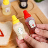 Mini 30ml Plastic Squeeze Bottles holding ketchup and mustard on a wooden cutting board with bread.