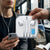 Advanced Smart Chip Lightning Charging Cable displayed alongside headphones in a bus setting.