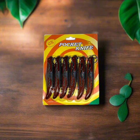 Compact Lightweight Pocket Knife six-pack in colorful packaging on a wooden surface.