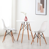 75cm Modern Eames Design Round Dining Table with stylish chairs and decorative vase in a bright room.