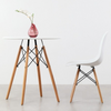75cm Modern Eames Design Round Dining Table with chair and decorative vase.