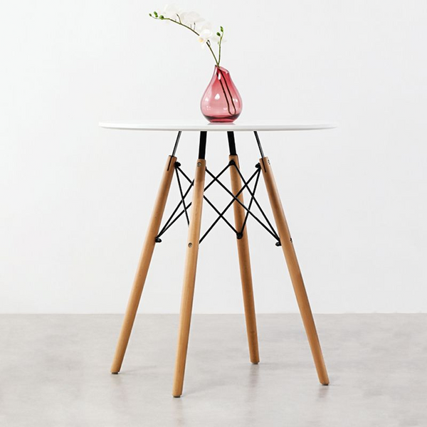 75cm Modern Eames Design Round Dining Table with minimalist design and a vase with flowers on top.