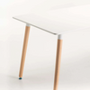 Close-up of Betty Wooden Leg Dining Table showing white tabletop and wooden legs, ideal for modern dining spaces.