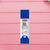 Quick-Dry Mini Glue Stick 9g – School & Office Adhesive in a blue package on a pink wooden background.