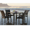 Rattan Patio Dinner Table Set on the beach with square glass top and four rattan dining chairs.