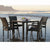 Rattan Patio Dinner Table Set on the beach with square glass top and four rattan dining chairs.