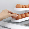 Refrigerator Egg Rolling Organiser for Storage with eggs being placed in a stacked holder in the fridge.