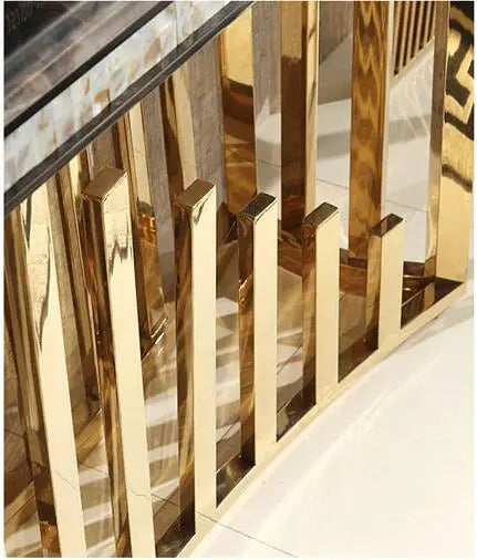 Close-up of the luxurious gold stainless steel details of the Luxury Gold Stainless Steel Marble Console Table.