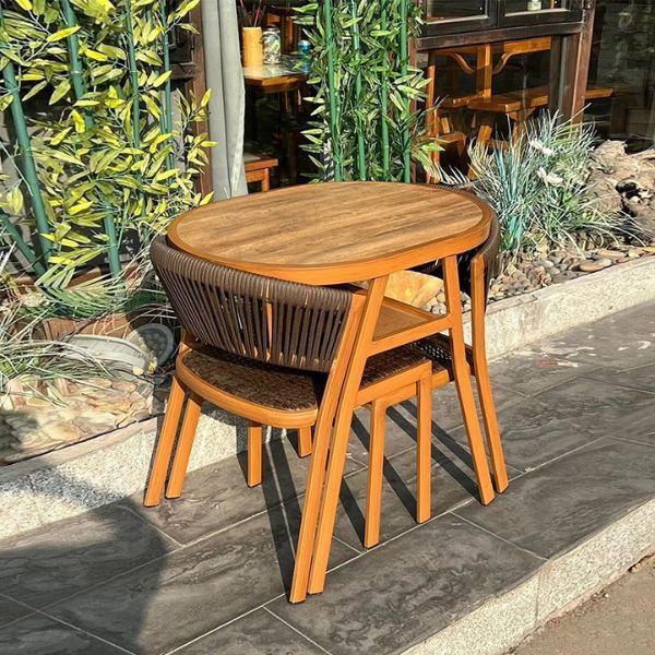 Space-Saving 3-Piece Outdoor Dining Set featuring a compact table and stacked chairs, ideal for small spaces.