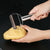 User peeling a potato with a Stainless Steel Handheld Vegetable & Fruit Peeler in the kitchen.