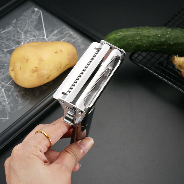 Stainless Steel Handheld Vegetable & Fruit Peeler being used to peel a potato and cucumber.