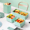 Two-Tier Leakproof Kids Lunch Box filled with healthy meals, fruits, and snacks, designed for mess-free transport.
