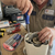 Professional using a 4-Piece Magnetic Precision Screwdriver Set for repairs on an appliance.