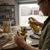 Man using Automatic 450ml Multi Surface Gold Spray Paint Can on a decorative project in a workshop.