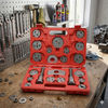 21pc Universal Brake Caliper Wind Back Tool Kit displayed on workbench with various tools and accessories.