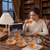 12 Piece Embossed Glass Coffee Cup and Saucer Set showcased with a woman enjoying tea in a vintage-style library.