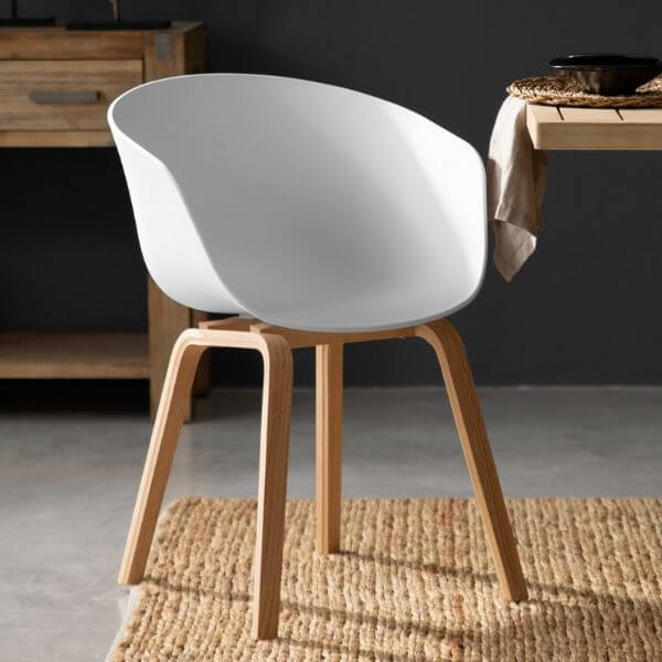 Modern White Dining Tub Chair featuring a smooth polypropylene seat and sturdy wooden base in a stylish dining setting.