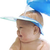 Baby wearing a Baby Shower Cap during bath time, smiling as water is poured for a fun and safe experience.
