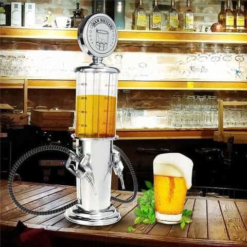 Bar Butler Liquor Pump showcasing a mini beer dispenser next to a glass of beer on a wooden table.
