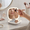 Using the Portable Rechargeable Seashell LED Mirror for makeup application with integrated LED lighting.