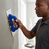 Man using a Plastering Trowel on a wall for a smooth finish.