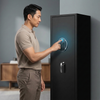 Man using fingerprint access on a Large Digital Safe with Fingerprint Access in a modern interior.