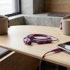 Compact True Wireless Bluetooth Earbuds on a wooden table next to two cups of coffee.