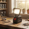 5-Inch Rechargeable LED Work Light placed on a workbench with tools, providing bright illumination for tasks.