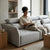 A woman reading on the SF-622B Modular Fabric Couch with adjustable headrests in a modern living room.