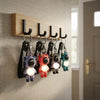 Colorful Astronaut Bear LED Keychain with Wrist Strap displayed on hooks, showcasing vibrant colors and illuminated features.
