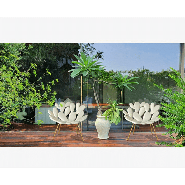 Urban Ease Contour Lounge Chair in a serene outdoor setting with greenery and modern decor.