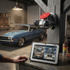 4-Lens PTZ Wi-Fi Security Camera Unit monitoring car in garage with tablet displaying live feed.