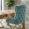 Cassander Dining Chair with tufted upholstery and gold metal base in a modern dining setting.