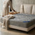 A cozy bedroom setting featuring a Modern Upholstered Bed Frame with a gray mattress and soft blanket.