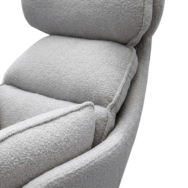 Close-up view of the soft cushioning of the Lamach Lounge Chair in a modern gray fabric.