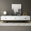 Urban Modern Media Console with a sleek white finish and gold accents, styled with decorative elements.