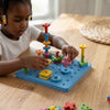 A child actively engaged with the DIY Geometric Peg Board Set, creating colorful geometric shapes and patterns.