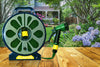 15m Flat Hose with Spray Nozzle on a wooden table, ready for outdoor watering in a garden setting.