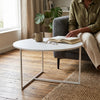 Scandinavian Round Coffee Table with a minimalist design, paired with a cozy living room setting.