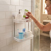 Woman organizing toiletries on the Space Nest 2-Tier Bathroom Corner Shelf in a stylish bathroom.