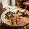 Colorful Silicone Capybara Keychain collection on a wooden table with a coffee cup, adding playful charm to accessories.