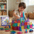 Child building a colorful castle with the 40-Piece Translucent Magnetic Building Tiles Set on a wooden floor.
