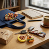 Silicone Capybara Keychain among colorful keychains on a table with a tote bag, cup, and notebook.