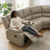 Woman relaxing on Wembley Luxury Recliner Sectional Couch with a drink in hand, showcasing its recline feature.