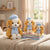 Beret Puppy Plush Toy trio arranged on books, showcasing their playful design and soft textures in a cozy setting.