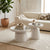 Modern White Round Coffee Table Set showcased in a stylish lounge with decorative items and seating.